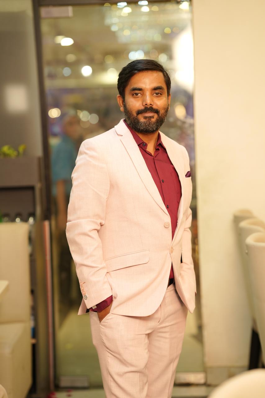 Parichay Parivesh wearing a light suit and burgundy shirt